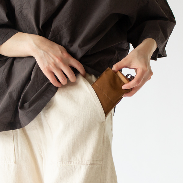 ボトムスのポケットにも入れられるスマートさ(CARAMEL)
