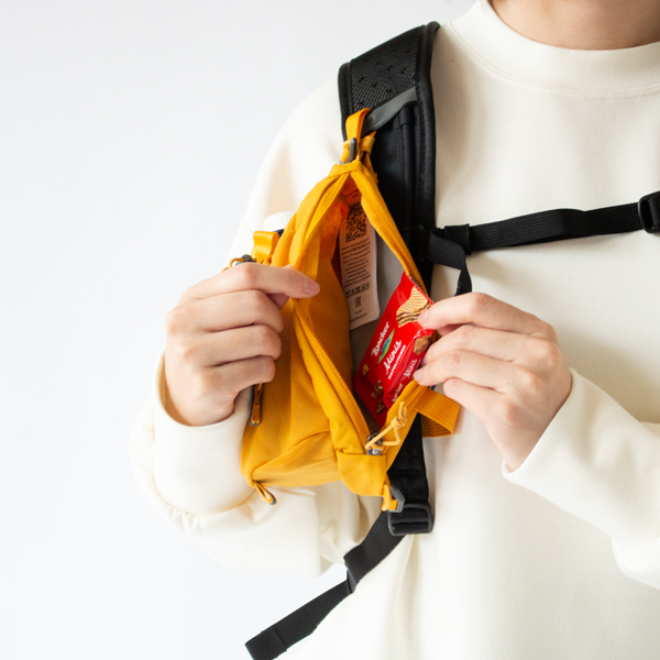 スマートフォンや行動食などを収納できるジッパー付きポケット(Mustard Yellow)